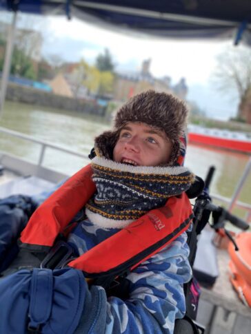 Participant smiling as he enjoys powerboat trip in Aiming Higher